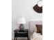 Side table with lamp and decor in bedroom with a decorative wall piece in background at 3422 S Grant St, Englewood, CO 80113