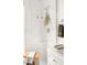 White, glass enclosed shower features marble-style tile and a wooden bench for comfortable showering at 3422 S Grant St, Englewood, CO 80113