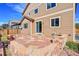 Backyard featuring a stone patio and stairs up to sliding glass door on the back of the house at 12762 Fisher St, Englewood, CO 80112