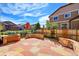 Backyard featuring a stone patio, landscaping, and a wood fence surrounding the property at 12762 Fisher St, Englewood, CO 80112