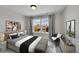 Cozy bedroom with large windows that provide natural light and neighborhood views at 12762 Fisher St, Englewood, CO 80112