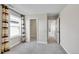 Bright bedroom with natural light, neutral walls, grey carpet and two access doors to the rest of the house at 12762 Fisher St, Englewood, CO 80112