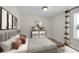 Well-lit bedroom with striped bedding, soft accents, and natural light from a window at 12762 Fisher St, Englewood, CO 80112