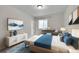 Cozy bedroom featuring a modern bed, a stylish desk and a dresser with trendy decor accents at 12762 Fisher St, Englewood, CO 80112
