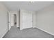 Bedroom featuring neutral toned walls, carpet, and a closet with sliding doors at 12762 Fisher St, Englewood, CO 80112