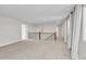 Spacious bonus room with neutral walls and carpet, offering a versatile living space with elegant chandelier at 12762 Fisher St, Englewood, CO 80112