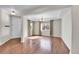 Formal dining room with hardwood floors, tray ceiling, large windows, and a white front door entrance at 12762 Fisher St, Englewood, CO 80112