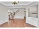 Elegant entryway featuring hardwood floors, an open staircase, decorative niche, and views to adjoining spaces at 12762 Fisher St, Englewood, CO 80112