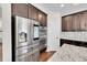 Close-up of kitchen featuring stainless steel appliances, granite counters and mosaic backsplash at 12762 Fisher St, Englewood, CO 80112
