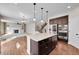 Open floor plan with kitchen island, stainless appliances, and a view of living room fireplace at 12762 Fisher St, Englewood, CO 80112