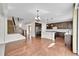 Open floor plan showing the kitchen and staircase with hardwood floors and a kitchen island at 12762 Fisher St, Englewood, CO 80112