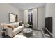 Contemporary living room with a comfortable white sofa, marble coffee table and ample natural light at 12762 Fisher St, Englewood, CO 80112