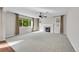 Spacious living room featuring neutral carpet, a modern fireplace, large windows, and soft, ambient lighting at 12762 Fisher St, Englewood, CO 80112