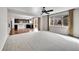Bright living room with large windows, ceiling fan, carpeted floor, and open access to the modern kitchen at 12762 Fisher St, Englewood, CO 80112