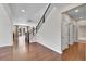Bright living room boasts hardwood floors, staircase and open floor plan to the kitchen at 12762 Fisher St, Englewood, CO 80112