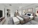 Well-lit main bedroom with a tray ceiling, king bed, and a view into the dining area at 12762 Fisher St, Englewood, CO 80112