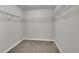 Walk-in closet with metal shelving and neutral carpet, providing ample storage space at 12762 Fisher St, Englewood, CO 80112
