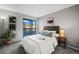Main bedroom with sliding door to balcony and en-suite bathroom at 8600 E Alameda Ave # 13-108, Denver, CO 80247