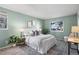Spacious bedroom with a sage green accent wall and plenty of natural light at 8600 E Alameda Ave # 13-108, Denver, CO 80247