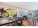 Cozy dining area with a rustic table and chairs, mountain mural, and hardwood floors at 8600 E Alameda Ave # 13-108, Denver, CO 80247