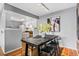 Modern dining area with dark wood table and kitchen view at 8600 E Alameda Ave # 13-108, Denver, CO 80247