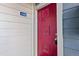 Exterior of building with a red front door and white siding at 8600 E Alameda Ave # 13-108, Denver, CO 80247
