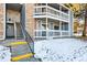 Exterior view of building showing stairs and snowy landscaping at 8600 E Alameda Ave # 13-108, Denver, CO 80247