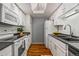 Bright kitchen with white cabinets, dark countertops, and modern appliances at 8600 E Alameda Ave # 13-108, Denver, CO 80247