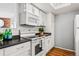 White kitchen with stainless steel appliances and dark countertops at 8600 E Alameda Ave # 13-108, Denver, CO 80247