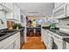 Bright kitchen features white cabinets, dark countertops, and a view into the dining area at 8600 E Alameda Ave # 13-108, Denver, CO 80247