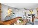 Bright living room featuring hardwood floors, modern decor, and an open layout into the dining area at 8600 E Alameda Ave # 13-108, Denver, CO 80247