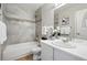Nicely tiled bathroom with tub, shower, vanity, and decorative accents at 2113 Coronado Pkwy # B, Denver, CO 80229