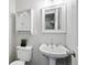 Cozy bathroom with pedestal sink and decorative mirror at 2113 Coronado Pkwy # B, Denver, CO 80229