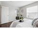 Bedroom with dark wood floors, a bed with decorative pillows and framed artwork at 2113 Coronado Pkwy # B, Denver, CO 80229