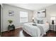 Bedroom with dark wood floors, a bed with decorative pillows and framed artwork at 2113 Coronado Pkwy # B, Denver, CO 80229