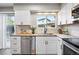 Well-lit kitchen boasts stainless steel appliances, sleek white cabinets, and butcher block counters at 2113 Coronado Pkwy # B, Denver, CO 80229