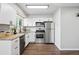 Bright kitchen with stainless steel appliances, white cabinets, and butcher block countertops at 2113 Coronado Pkwy # B, Denver, CO 80229