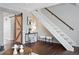 Living room showcases stairs and a sliding barn door entrance with modern decor accents at 2113 Coronado Pkwy # B, Denver, CO 80229