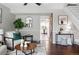Bright living room showcasing hardwood floors and a sliding barn door that leads to the kitchen at 2113 Coronado Pkwy # B, Denver, CO 80229