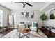 Cozy living room features stylish decor, comfortable seating, and a modern ceiling fan at 2113 Coronado Pkwy # B, Denver, CO 80229