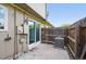 Cozy patio with sliding glass door, wooden fence, and AC unit for outdoor enjoyment at 2113 Coronado Pkwy # B, Denver, CO 80229