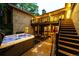 Beautiful backyard with manicured lawn, deck, and patio featuring a hot tub, perfect for relaxing at 10601 E Crestline Ave, Englewood, CO 80111