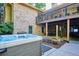 Backyard area featuring a hot tub, patio, and a covered patio with a table and chairs at 10601 E Crestline Ave, Englewood, CO 80111