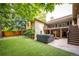 Beautiful backyard with manicured lawn, deck, and patio featuring a hot tub, perfect for relaxing at 10601 E Crestline Ave, Englewood, CO 80111