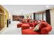 Finished basement featuring a red sectional sofa, a bar, and lots of room to spread out at 10601 E Crestline Ave, Englewood, CO 80111