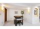Finished basement area features a round table with chairs, white walls, and modern lighting at 10601 E Crestline Ave, Englewood, CO 80111