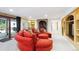 Finished basement with an eye-catching red sectional sofa, a brick arch, and a sliding glass door at 10601 E Crestline Ave, Englewood, CO 80111