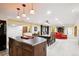 Open basement featuring a dining table, island, kitchen, a decorative fireplace, and comfortable seating at 10601 E Crestline Ave, Englewood, CO 80111