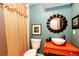 Charming bathroom with unique orange vanity, statement mirror, and modern fixtures at 10601 E Crestline Ave, Englewood, CO 80111
