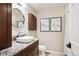 Modern bathroom featuring a vessel sink, granite countertop, decorative art, and stylish fixtures at 10601 E Crestline Ave, Englewood, CO 80111